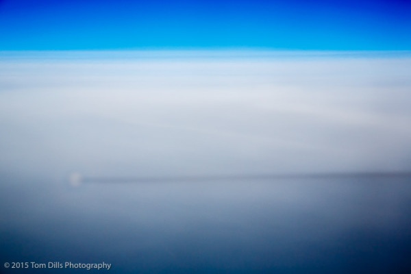 Shadow of our plane and contrail on the clouds during our flight from Key West to Charlotte